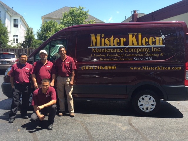 Mister Kleen team posing in front of company van